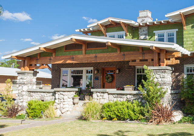 Craftsman style home with stone piers, deep eaves and exposed rafters