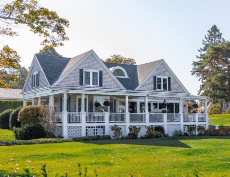 Historic farmhouse with a wide front porch and lawn